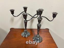 A pair of vintage sterling silver weighted candelabra candlesticks