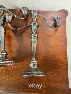 A pair of vintage sterling silver weighted candelabra candlesticks