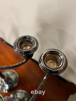 A pair of vintage sterling silver weighted candelabra candlesticks