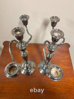 A pair of vintage sterling silver weighted candelabra candlesticks