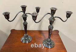A pair of vintage weighted silver plated candelabra candlesticks