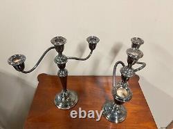 A pair of vintage weighted silver plated candelabra candlesticks