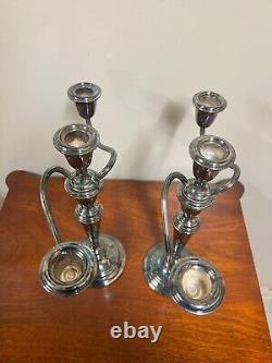 A pair of vintage weighted silver plated candelabra candlesticks