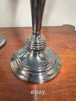 A pair of vintage weighted silver plated candelabra candlesticks