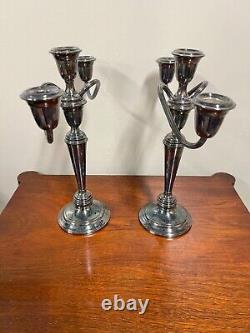 A pair of vintage weighted silver plated candelabra candlesticks