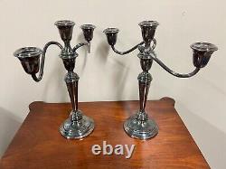 A pair of vintage weighted silver plated candelabra candlesticks