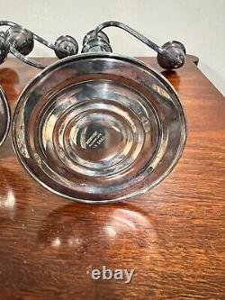 A pair of vintage weighted silver plated candelabra candlesticks