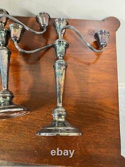 A pair of vintage weighted silver plated candelabra candlesticks