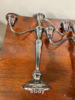 A pair of vintage weighted silver plated candelabra candlesticks