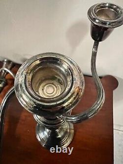 A pair of vintage weighted silver plated candelabra candlesticks