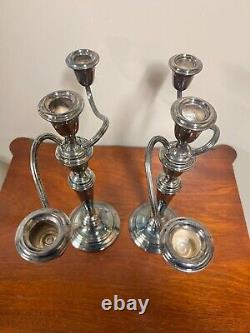 A pair of vintage weighted silver plated candelabra candlesticks