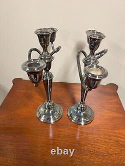 A pair of vintage weighted silver plated candelabra candlesticks