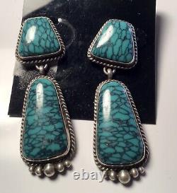 A vintage pair of sterling silver turquoise dangle earrings by Navajo Ben Piaso