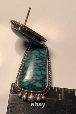 A vintage pair of sterling silver turquoise dangle earrings by Navajo Ben Piaso