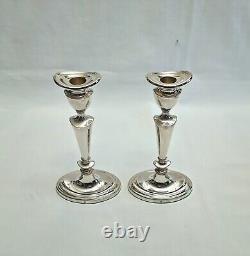 An eight inch pair of vintage sterling silver candlesticks by D. J silver, London