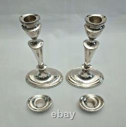 An eight inch pair of vintage sterling silver candlesticks by D. J silver, London