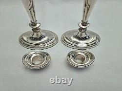 An eight inch pair of vintage sterling silver candlesticks by D. J silver, London