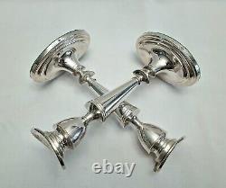 An eight inch pair of vintage sterling silver candlesticks by D. J silver, London