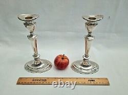 An eight inch pair of vintage sterling silver candlesticks by D. J silver, London