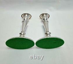 An eight inch pair of vintage sterling silver candlesticks by D. J silver, London